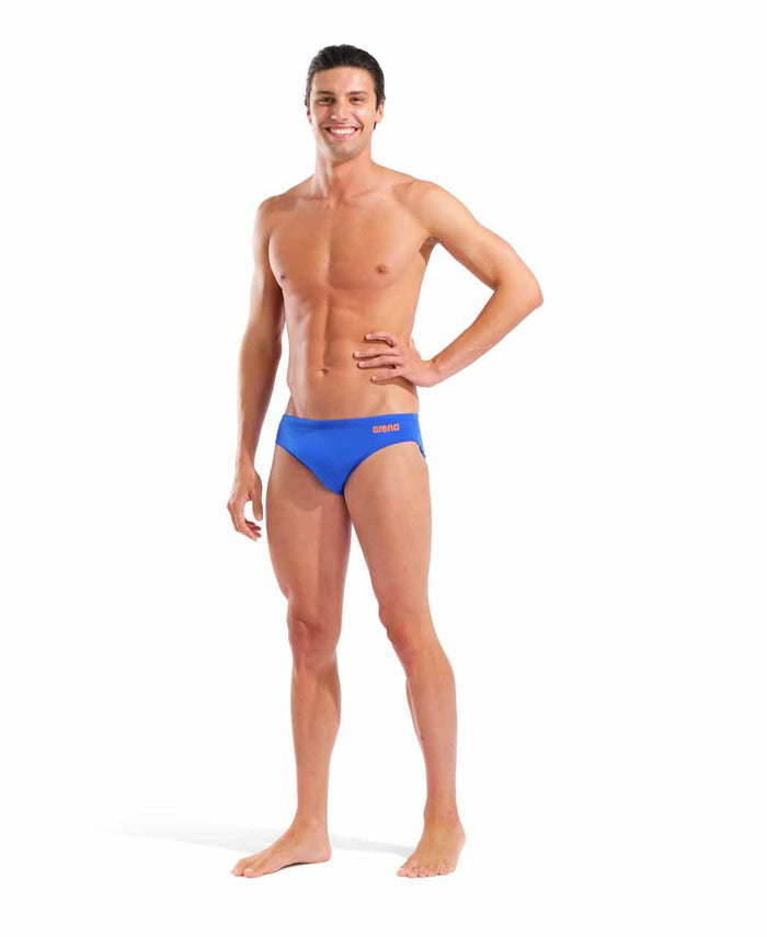 Arena men's team swim briefs in neon blue and orange, featuring a snug fit and solid color design for competitive swimming.