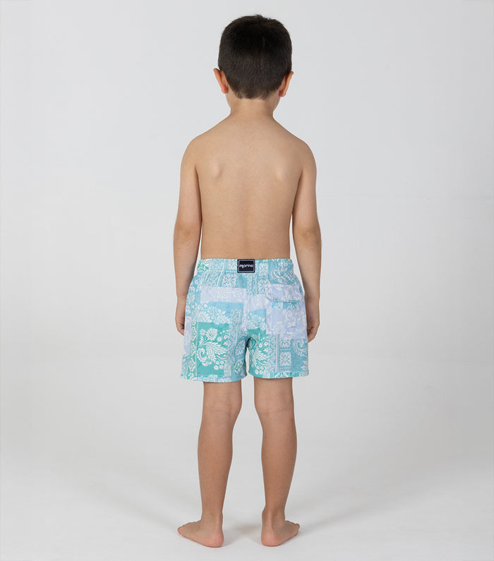 paisley Child wearing a turquoise patterned swim trunk on a white background
