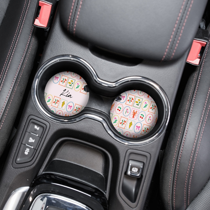 Set of Dolce Vita car coasters with zodiac designs and the name Lin customised on a decorative background.