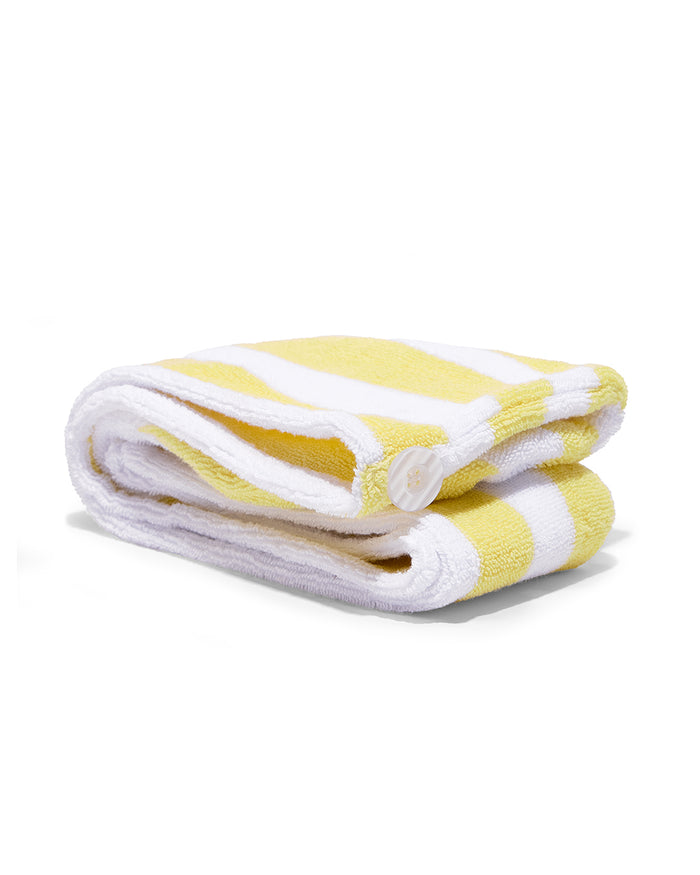 Yellow and white striped towel on a white background