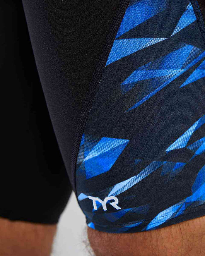 TYR men's Triadic Blade Splice jammer in blue, close-up view showing the sleek swimwear design and branding details.