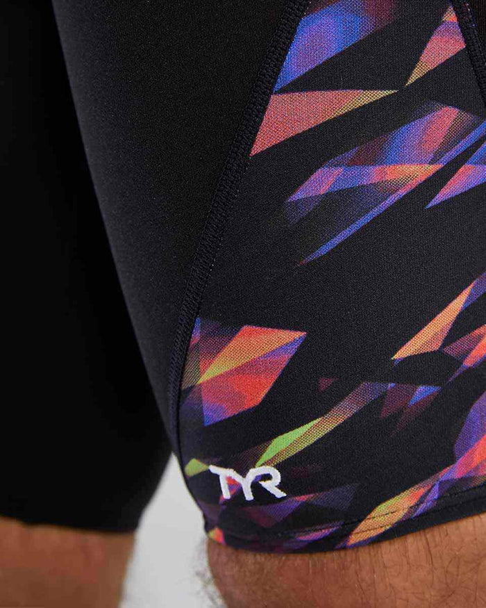 TYR men's Triadic Blade Splice jammer in multi-color, close-up view showing the fitted swimwear design and vibrant pattern.
