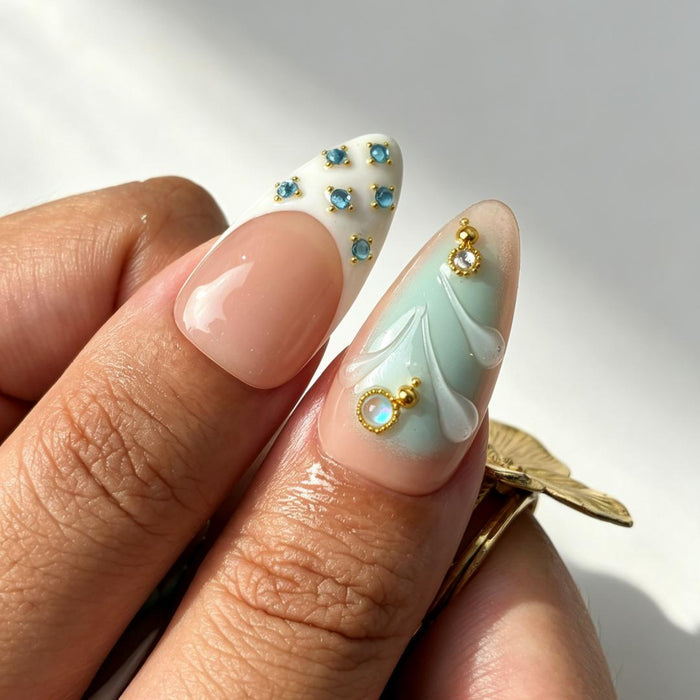 Nude base mint leopard rhinestone fake nails close‑up