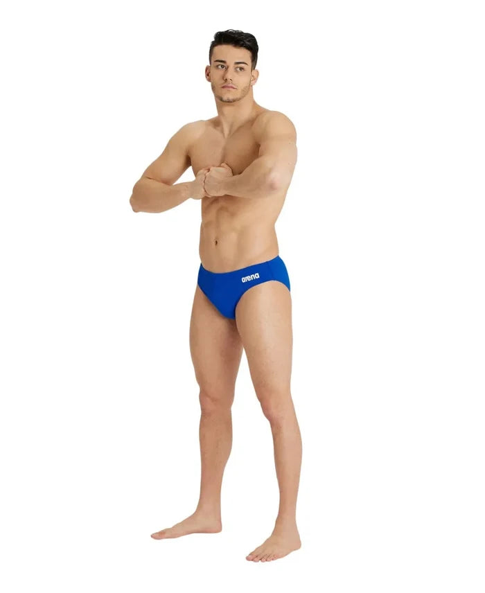 Blue Arena men's swim briefs with a solid design, featuring a snug fit and elastic waistband for competitive swimming.