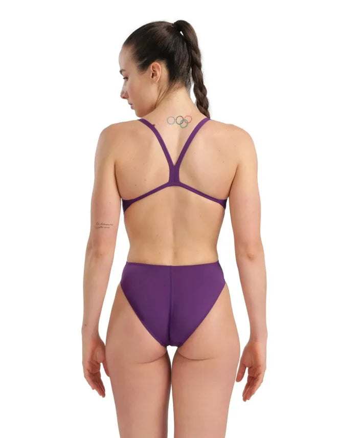 Arena women's solid Team Challenge swimsuit in plum and white, with a sleek, supportive design for competitive swimming.