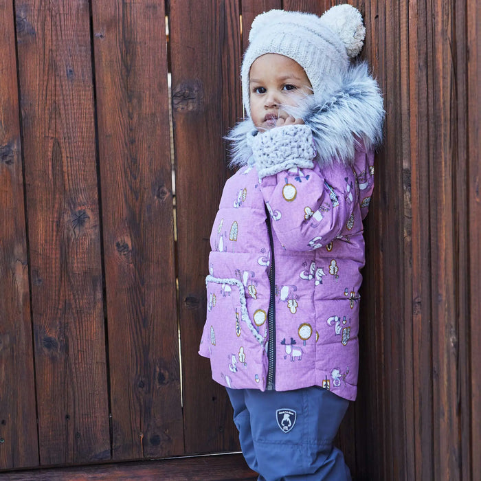 Baby girl in Deux par Deux two-piece winter snowsuit with Lilac printed jacket and solid snow overalls.
