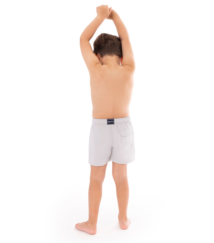 Gray Young boy wearing light gray shorts on a white background
