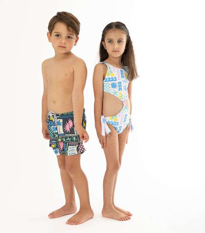 Capri Black Two children wearing colorful swimwear on a white background