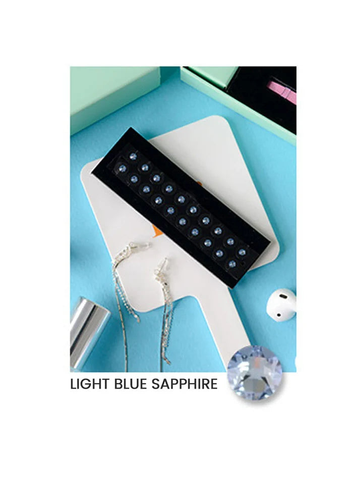 Light blue sapphire stone on a white stand with a blue background