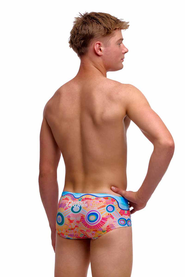 Funky Trunks Boys Kulin Colour Sidewinder Trunks in vibrant multi-color pattern, worn by a young boy.