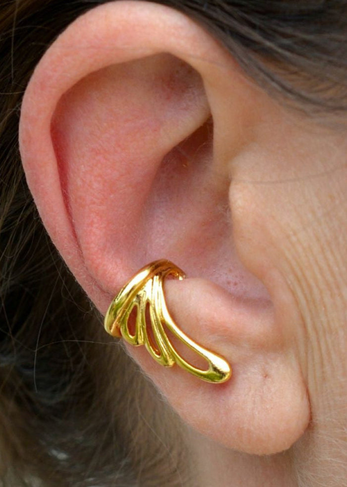 gold flowy wing ear cuff worn on ear non piercing earring side view