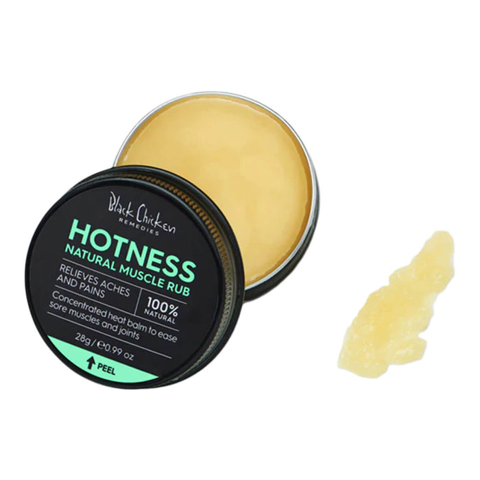 Open container of natural vegan heat balm for sore muscles next to a swatch.