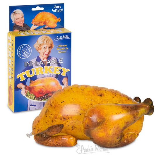 A display showcases the Inflatable Turkey alongside its packaging, which depicts a smiling woman proudly presenting the Thanksgiving table centerpiece.