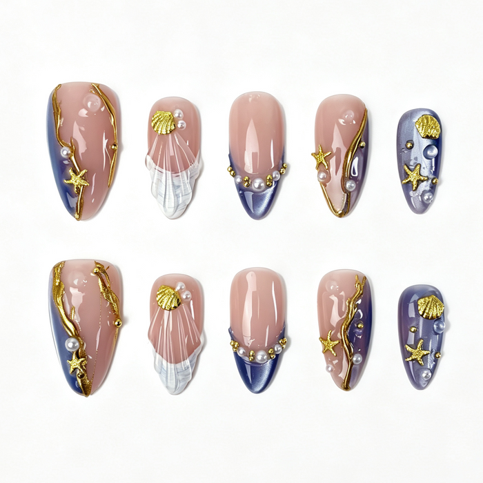 Lilac Tide medium almond press on nails, sheer nude lilac gradient with gold foil, seashell, starfish and layered pearl decor