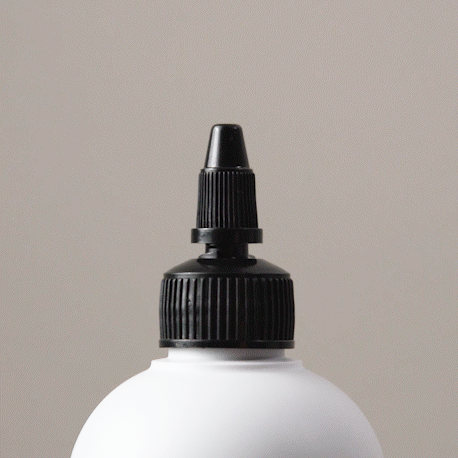 Gif showing the Alcôve Hair Violet Conditioner coming out of the nozzle of the bottle