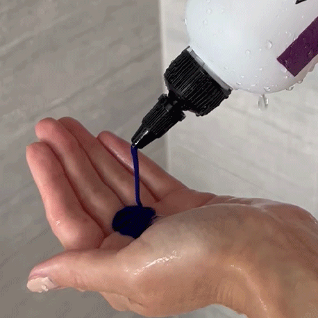 Gif showing someone pour Violet Shampoo - Alcôve Hair into their hand in the shower