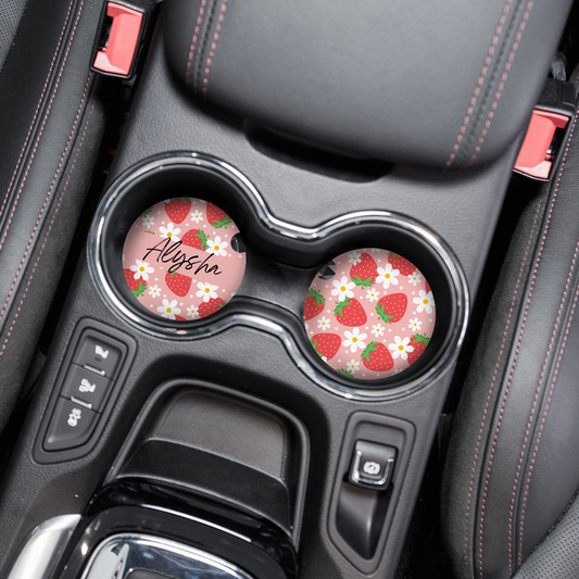 Round car coasters with a pink strawberry pattern and personalised name, glossy finish.