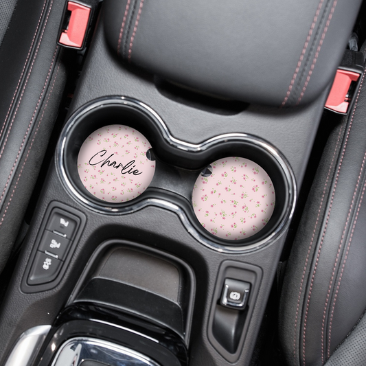 Pair of pink floral car coasters, one with a cursive name, featuring Coconut Lane’s ditsy pattern.