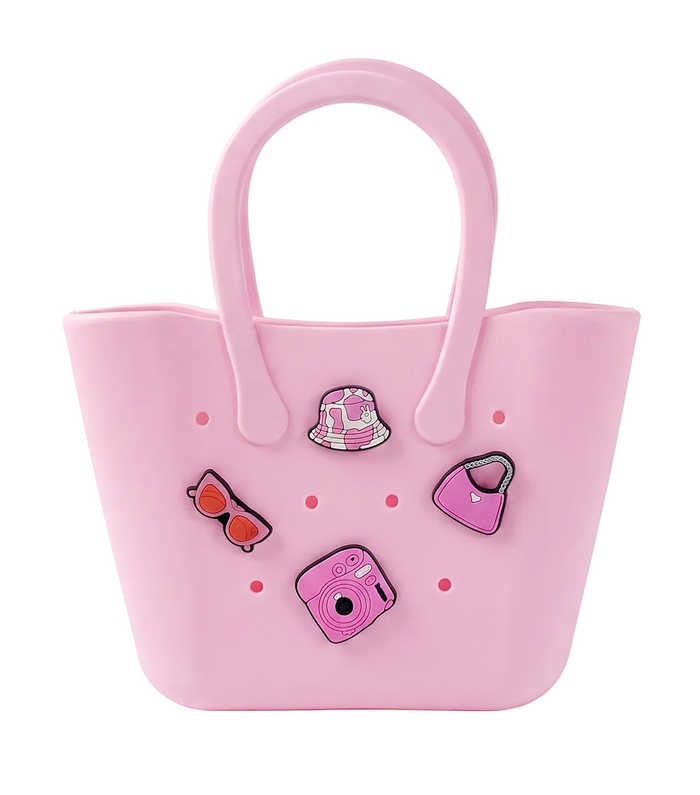 Pink silicone bag with decorative pins on a white background