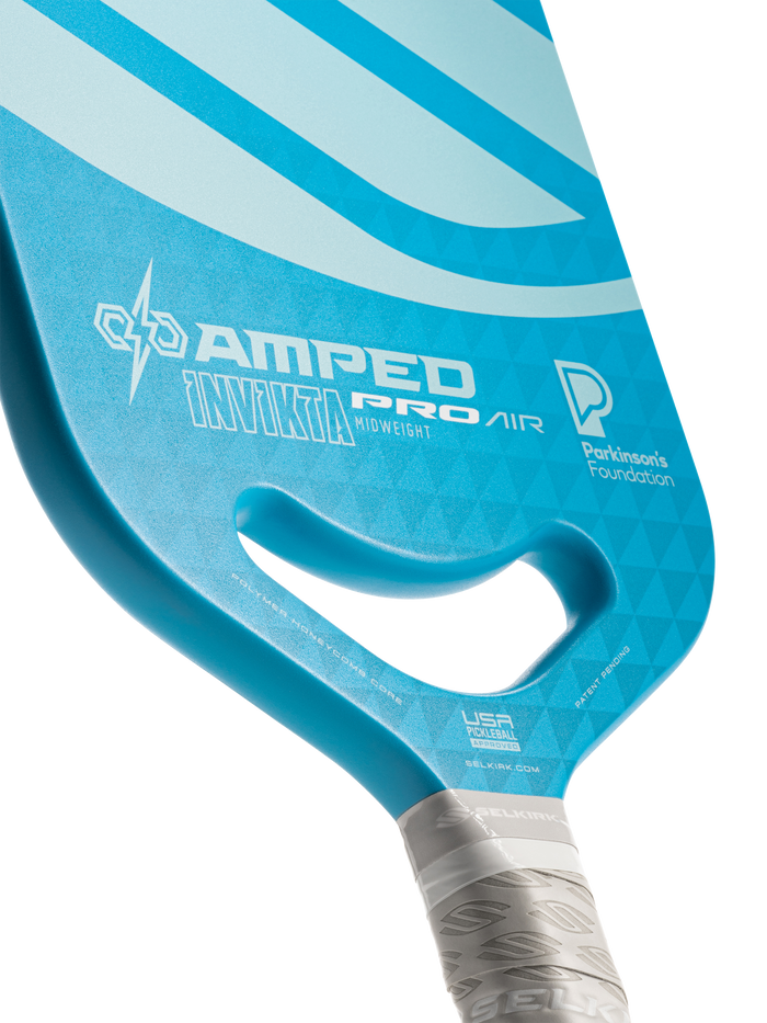 Blue Selkirk paddle labeled AMPED PRO AIR INVICTA MIDWEIGHT with Parkinson's Foundation logo, USA Pickleball and selkirk.com