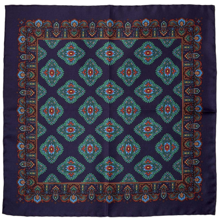 A KirbyAllison.com Sovereign Grade 100% Silk Navy Pocket Square featuring a blue and green paisley design on a white background.