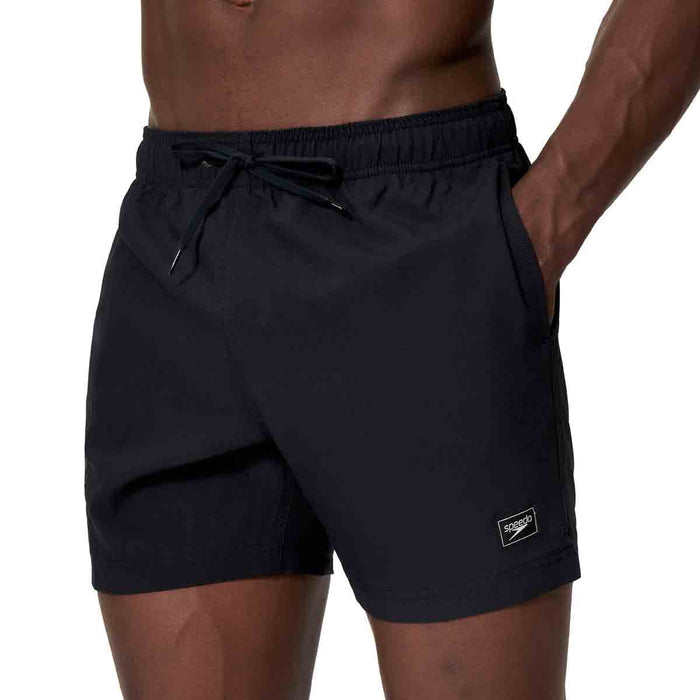 Black Speedo men's Essentials 16-inch swim shorts with a comfortable fit and quick-drying fabric, designed for swim and beach activities.