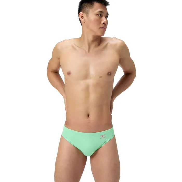 Speedo men's solid brief in Alfalfa Green, colorful swimwear with a snug fit, featuring the Speedo logo on the waistband.
