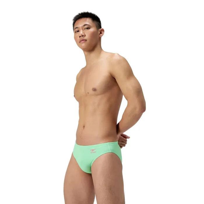 Speedo men's solid brief in Alfalfa Green, lightweight swimwear with a snug fit, designed for comfort and performance.