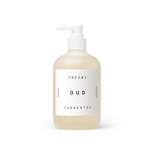 A pump bottle of Tangent GC Oud Body Wash with a clear liquid visible inside. The label has white and black text with the brand name and product type indicated.