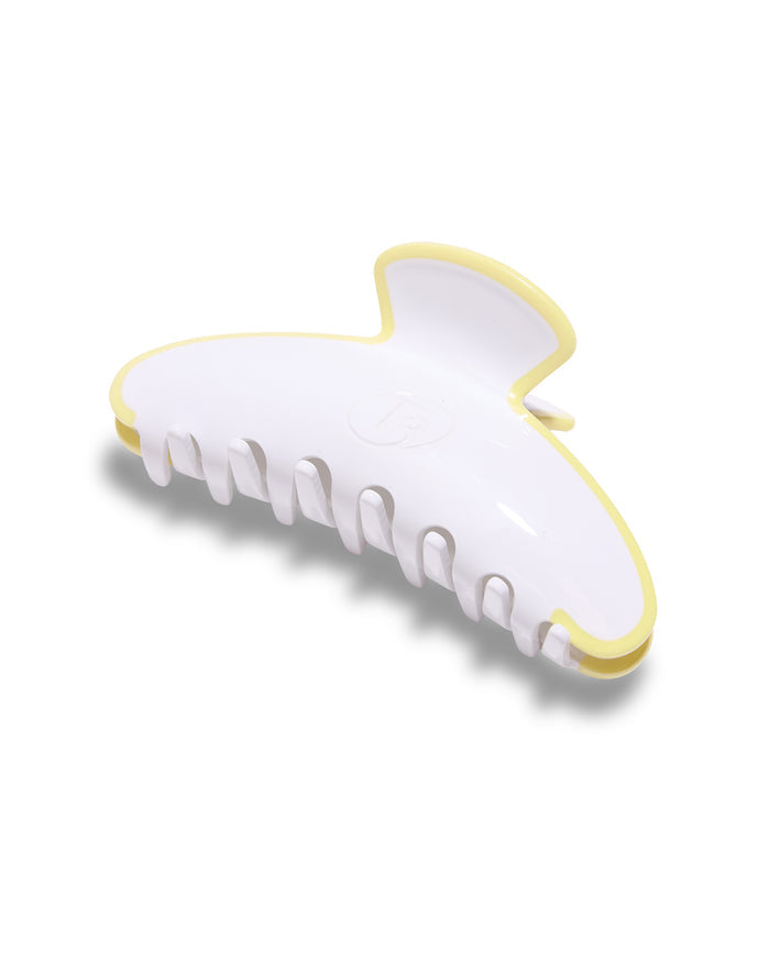 White hair clip with yellow accents on a white background