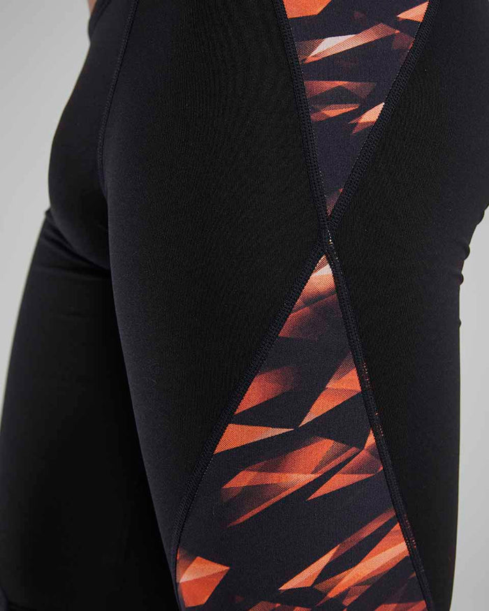 TYR men's Triadic Blade Splice jammer in bright orange, designed for competitive swimming with a sleek, streamlined fit.