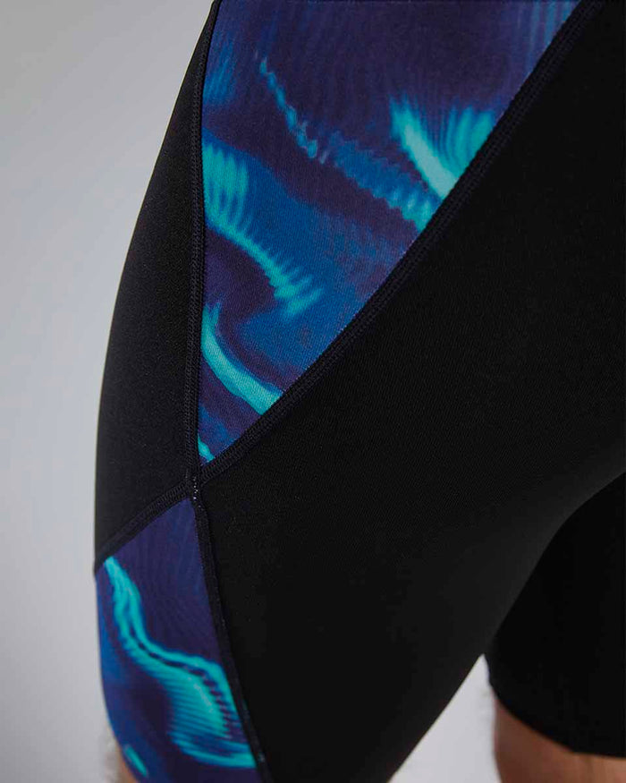 TYR men's Waveform Blade Splice jammer in blue and green, close-up of the fitted swim jammer with colorful design.