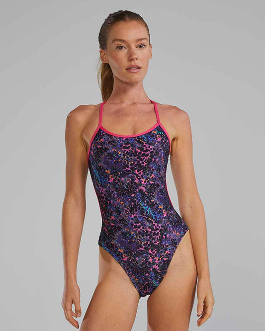TYR women's Stipple Trinityfit swimsuit in petunia, featuring a sleek design and supportive fit, shown on a model.