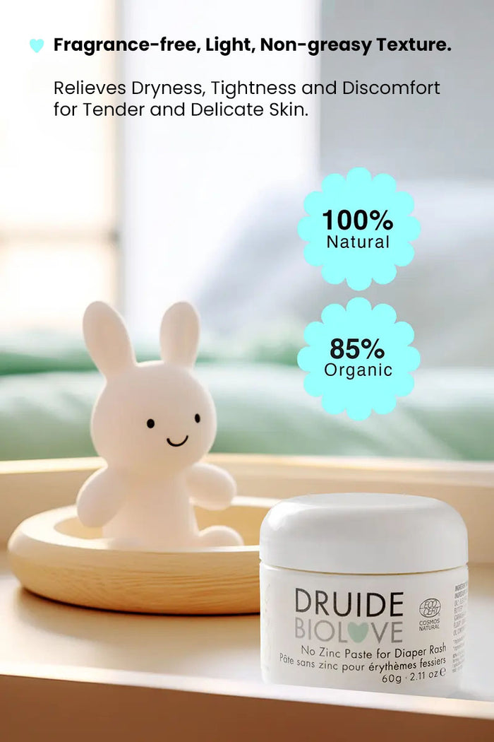 Druide Biolove organic baby balm tub on table with a teddy bear in background and text reading "100% natural 85% organic, fragrance free, light, non greasy texture, relieves dryness, tightness and discomfort for tender and delicate skin".